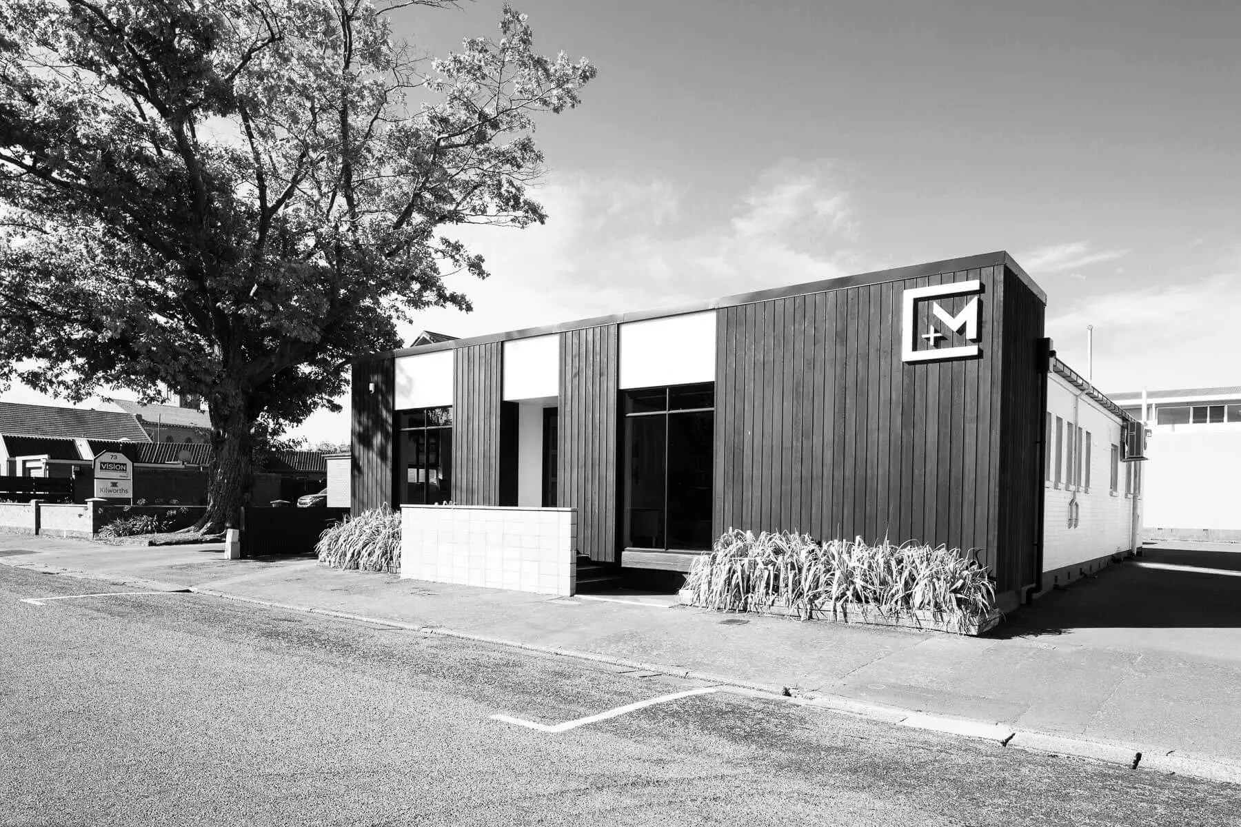 Chilton + Mayne architectural design studio at Ashburton– dark timber-clad building with C+M signage