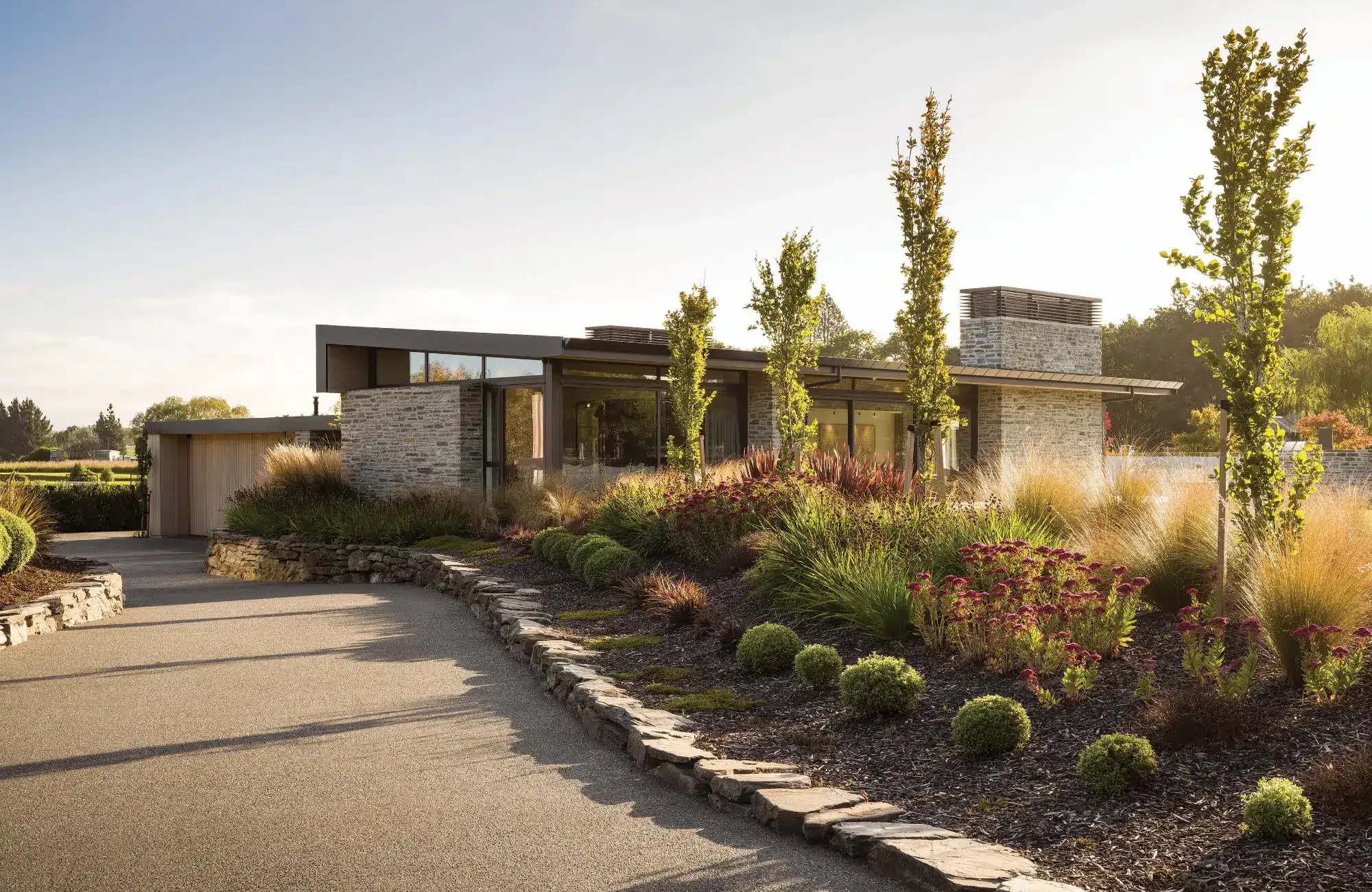 Single-storey rural home with stone cladding and native planting, designed by Chilton + Mayne architectural designers, Canterbury